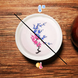 Magiska blommor som blommar te sakekopp, keramisk mugg som ändrar is/het färg